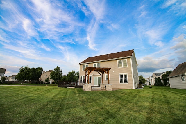 rear view of property featuring a lawn, cooling unit, and a pergola