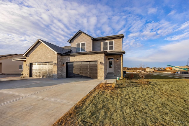 view of front facade featuring a front yard, brick siding, and driveway