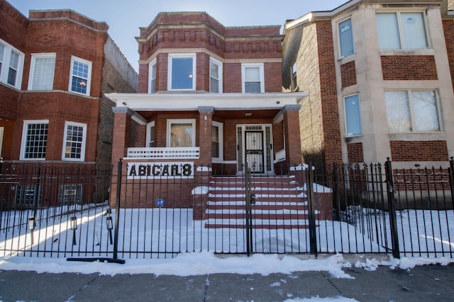 townhome / multi-family property featuring fence and brick siding