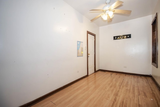 unfurnished room with ceiling fan, light wood-type flooring, and baseboards