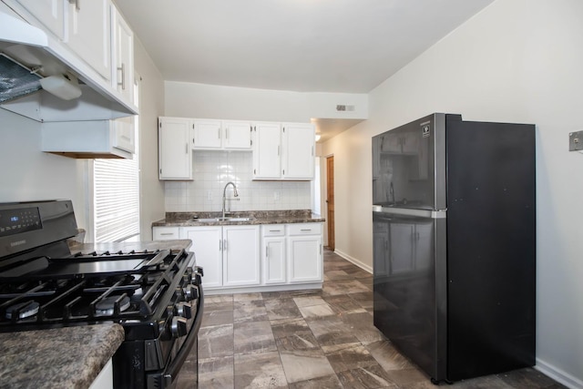 kitchen featuring black appliances, under cabinet range hood, white cabinets, and a sink