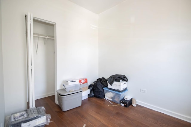 bedroom featuring dark wood finished floors and baseboards