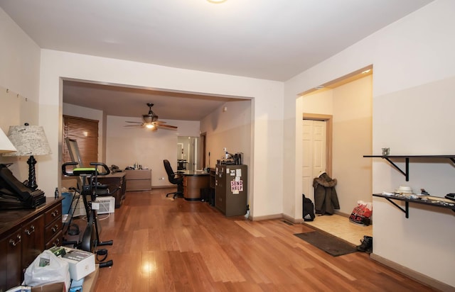 office with light wood finished floors, baseboards, and a ceiling fan