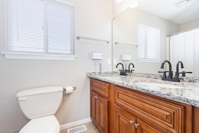 full bathroom with double vanity, a sink, and visible vents