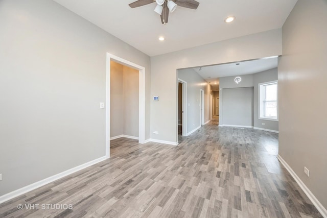 spare room featuring light wood-style floors, recessed lighting, ceiling fan, and baseboards