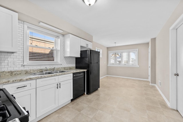 kitchen featuring tasteful backsplash, baseboards, white cabinets, black appliances, and a sink