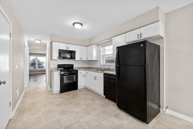 kitchen with black appliances, white cabinetry, and decorative backsplash