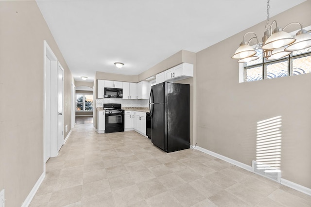 kitchen with decorative backsplash, light countertops, black appliances, white cabinetry, and pendant lighting