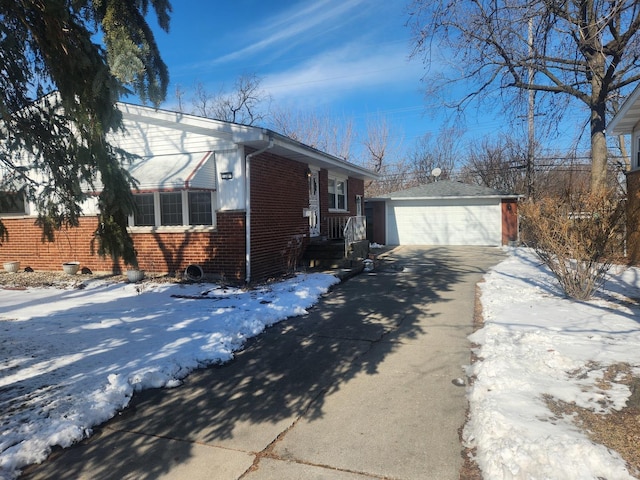 view of front of home with a garage, an outbuilding, and brick siding