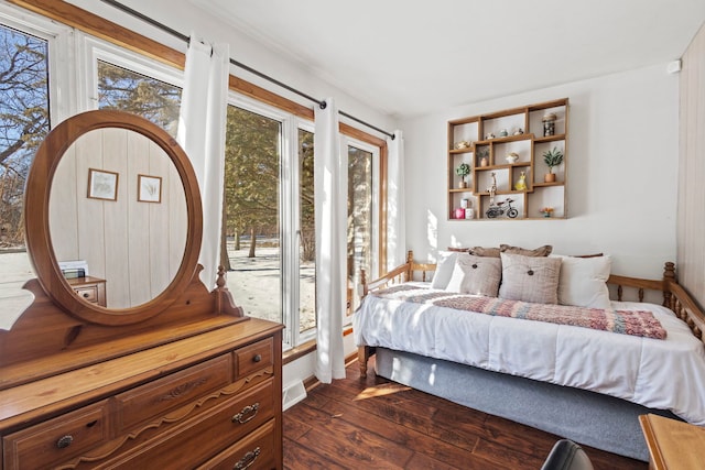 bedroom with dark wood-style floors, visible vents, and baseboards