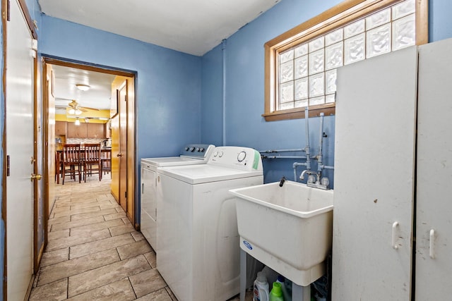 laundry area featuring laundry area, washing machine and dryer, a ceiling fan, and a sink