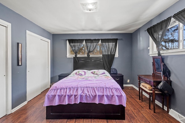 bedroom featuring visible vents, dark wood finished floors, and baseboards