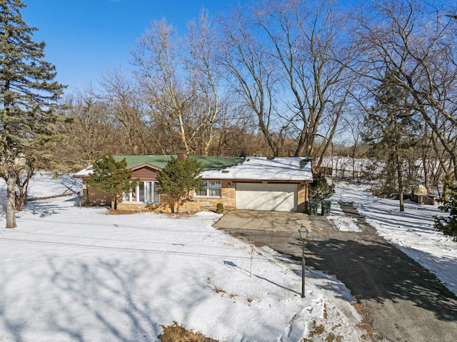 view of front facade featuring concrete driveway, brick siding, and an attached garage