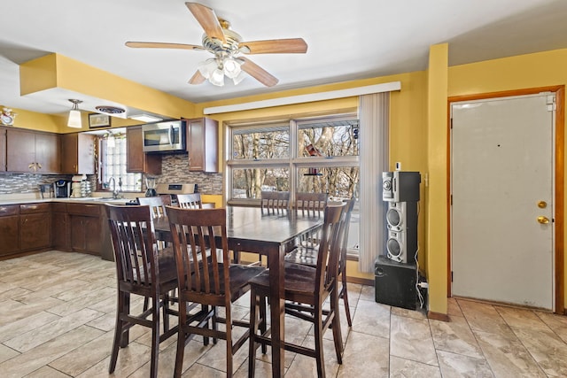 dining room with a ceiling fan