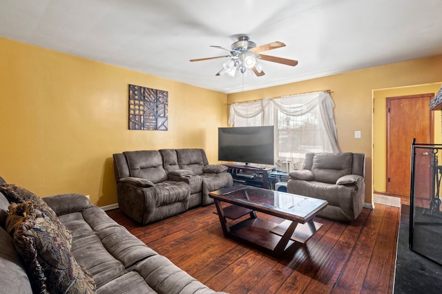 living area with dark wood-type flooring and ceiling fan