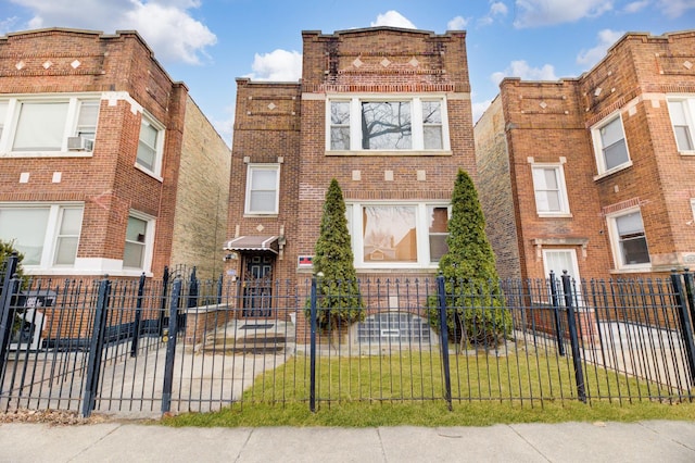 view of front of house with brick siding and a fenced front yard