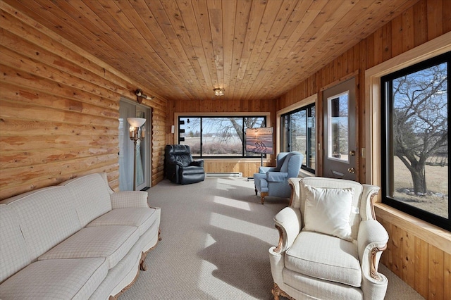 sunroom with a baseboard heating unit and wood ceiling