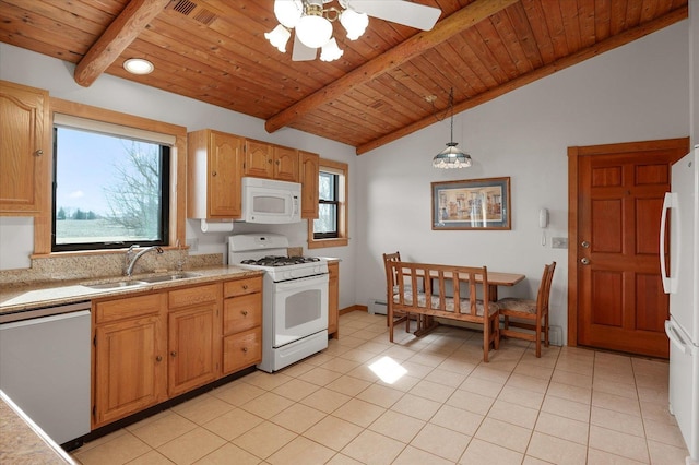 kitchen with white appliances, light countertops, a sink, and light tile patterned flooring