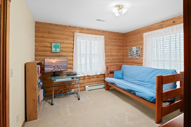 office area with a healthy amount of sunlight, rustic walls, a baseboard heating unit, and carpet floors