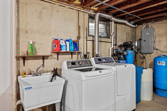 clothes washing area with laundry area, electric panel, a sink, and washing machine and clothes dryer