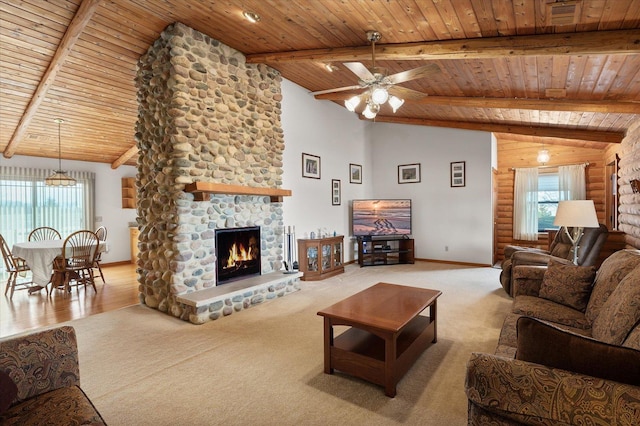 carpeted living area featuring wood ceiling, a fireplace, and a wealth of natural light