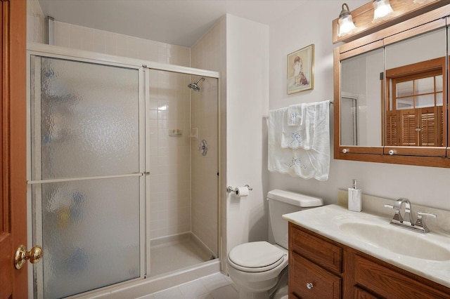 bathroom featuring a stall shower, vanity, and toilet