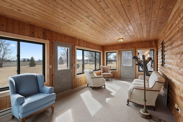 living area with carpet floors, wooden ceiling, wood walls, and baseboard heating