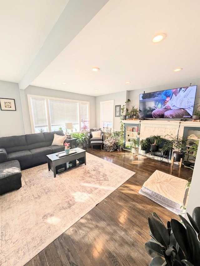 living area with beam ceiling, wood finished floors, and recessed lighting