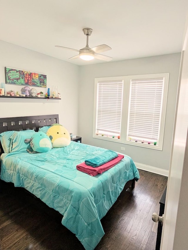 bedroom featuring a ceiling fan, baseboards, and dark wood-style flooring