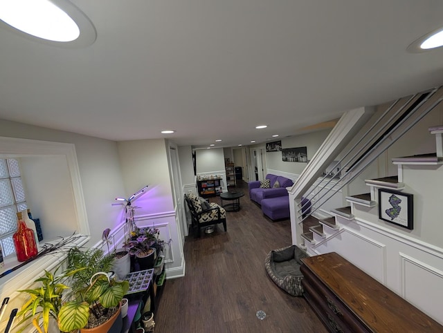 living area with recessed lighting, dark wood finished floors, and stairs