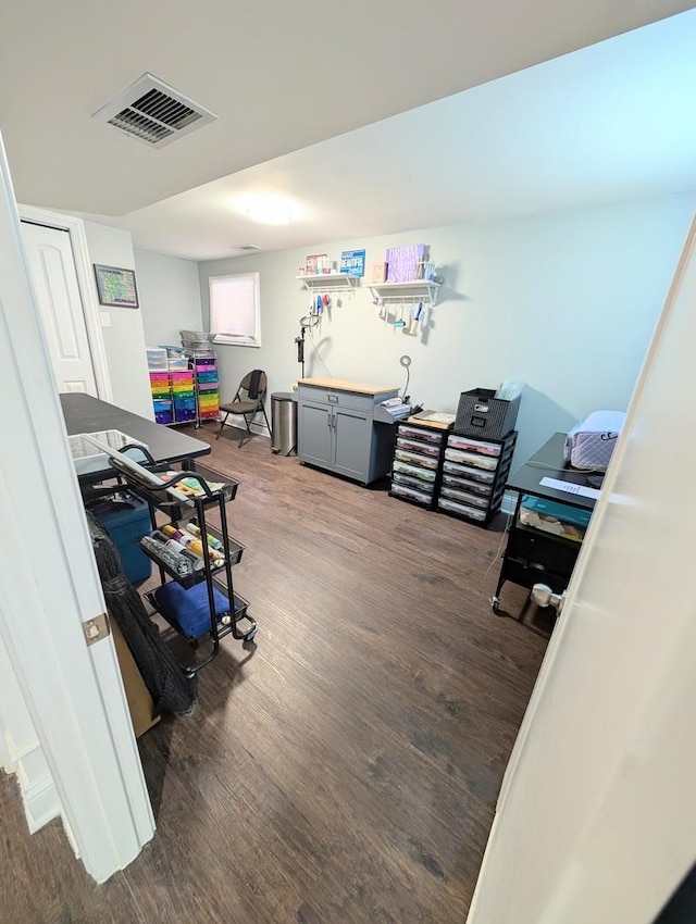 home office featuring dark wood-type flooring and visible vents