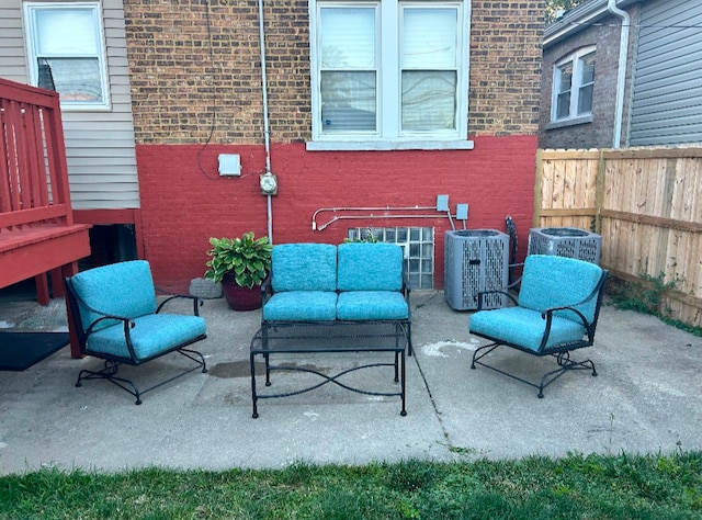 view of patio / terrace featuring fence and central AC