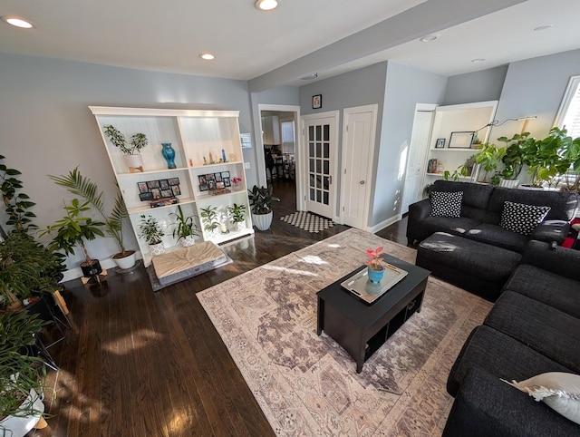 living area featuring baseboards, dark wood finished floors, and recessed lighting