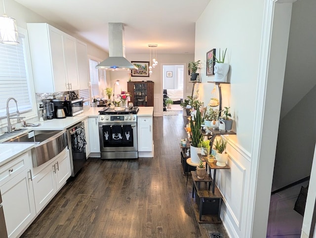 kitchen featuring island exhaust hood, pendant lighting, stainless steel appliances, and light countertops