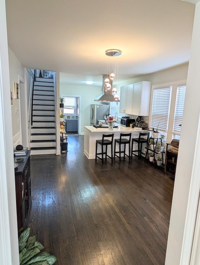 dining area with stairs, dark wood finished floors, and baseboards