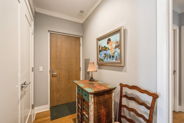 entryway with wood finished floors and visible vents