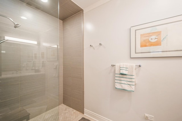 full bathroom with baseboards and tiled shower