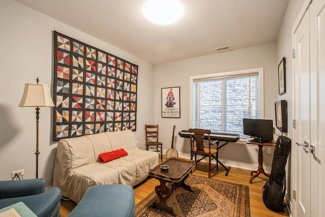 office featuring visible vents, baseboards, and wood finished floors