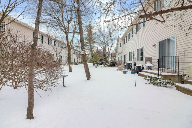 yard covered in snow with central AC unit