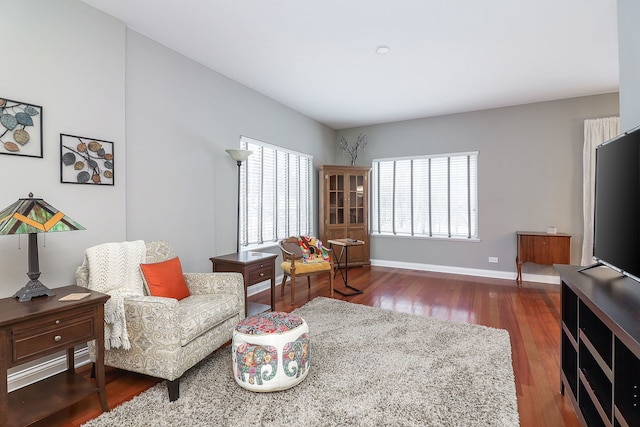 sitting room featuring dark wood-type flooring and baseboards