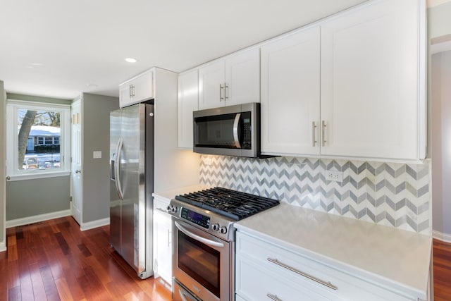 kitchen featuring tasteful backsplash, white cabinetry, appliances with stainless steel finishes, and light countertops