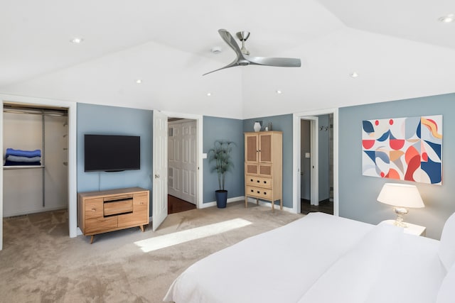 bedroom featuring a walk in closet, lofted ceiling, light colored carpet, ceiling fan, and baseboards