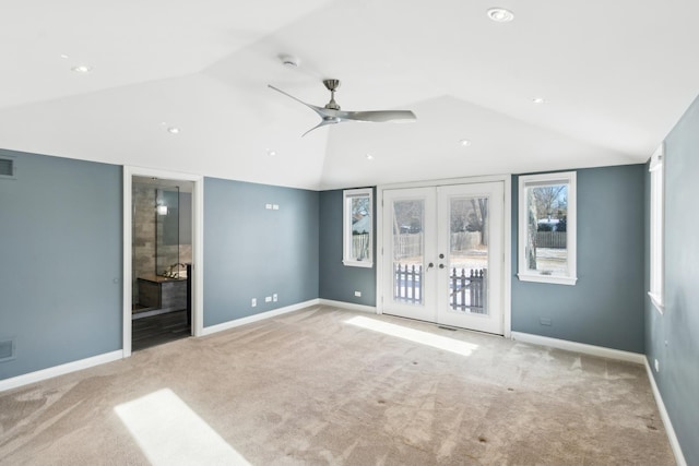 unfurnished room with french doors, light colored carpet, vaulted ceiling, and baseboards