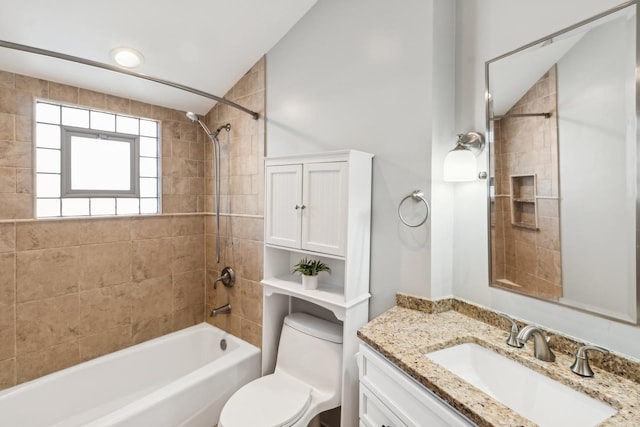 full bath featuring toilet, tub / shower combination, vaulted ceiling, and vanity