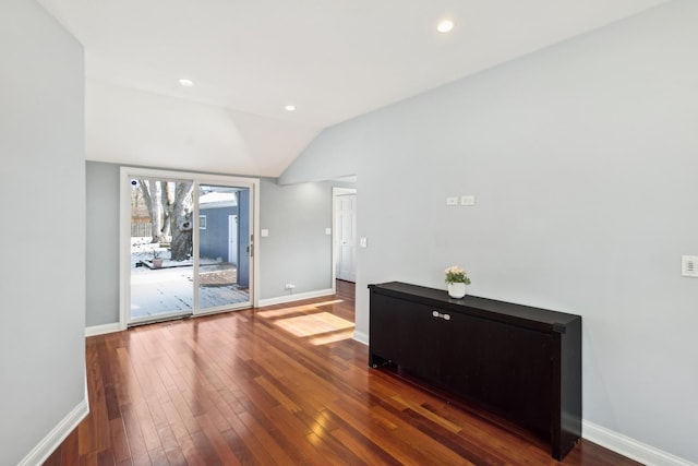 interior space featuring lofted ceiling, baseboards, dark wood finished floors, and recessed lighting