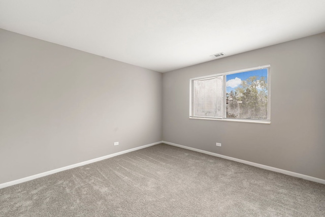 unfurnished room featuring carpet floors, baseboards, and visible vents