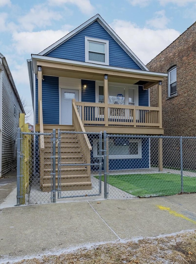 view of front of property featuring covered porch, a fenced front yard, and a gate