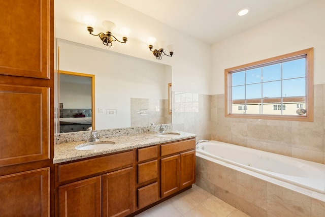 ensuite bathroom with double vanity, ensuite bath, a sink, and tile patterned floors