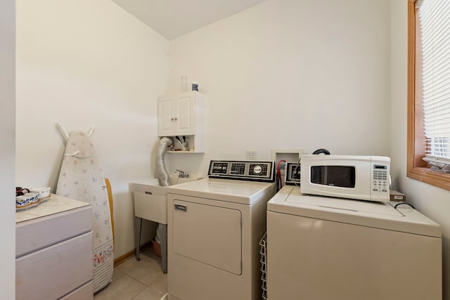 washroom with laundry area, washer and clothes dryer, and light tile patterned floors