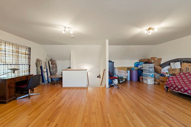 office space with light wood finished floors and vaulted ceiling